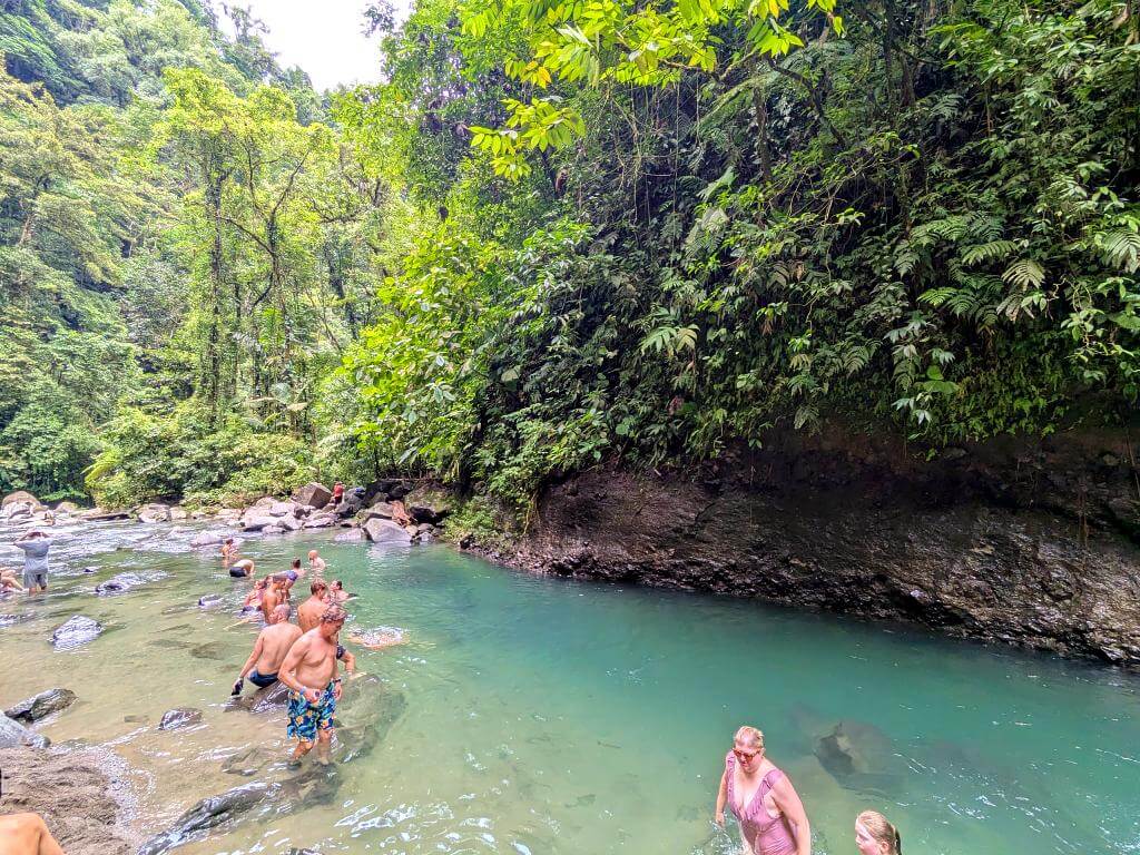 A calm natural pool in La Fortuna River, downstream from La Fortuna Waterfall, nestled in the rainforest near Arenal Volcano National Park.