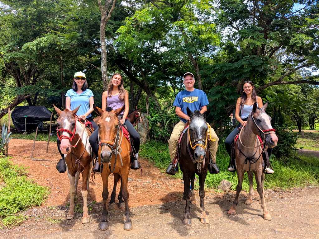 Tourists horseback riding, a traditional transportation method in rural Costa Rica.