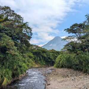 View of Agua Caliente River, lush riparian forest, and the towering Arenal Volcano from Shailee's Arenal Volcano View Point.