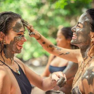 Two girls applying thermal mud to their faces, enjoying a relaxing facial treatment.