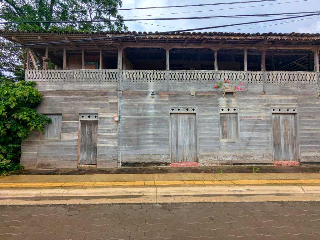 Front view of the Casona Cultural, showcasing the simple wooden structure with small welcoming details that add a cozy touch.