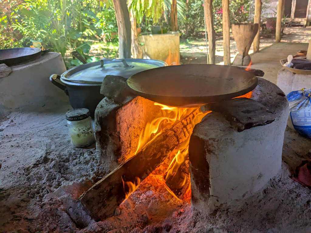 Traditional comal placed on a wood-fired clay stove for preparing handmade corn tortillas